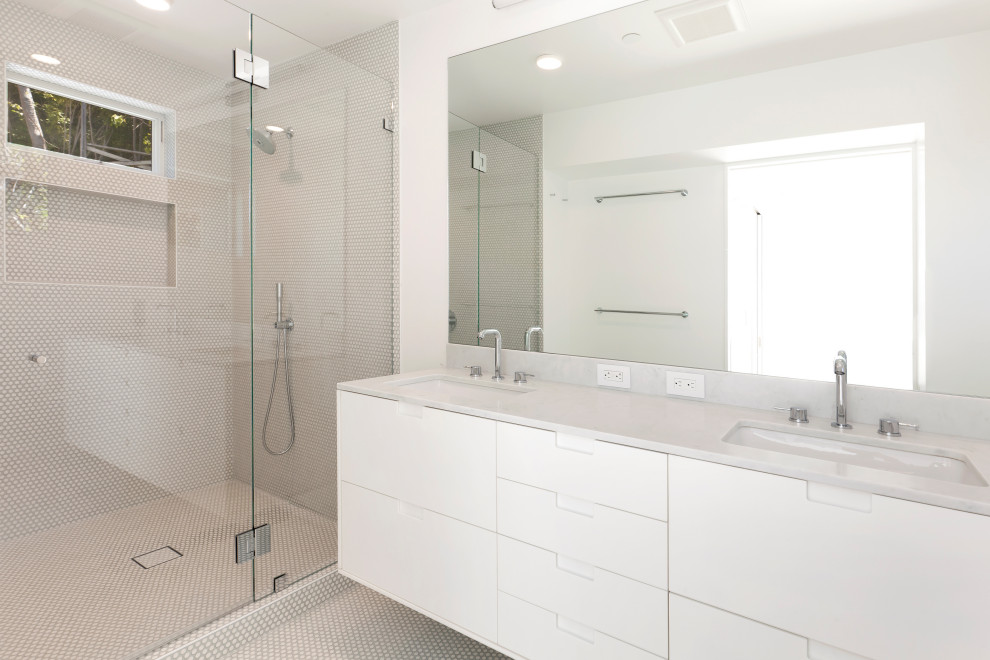 Large mediterranean ensuite bathroom in San Francisco with flat-panel cabinets, white cabinets, an alcove shower, a wall mounted toilet, white tiles, mosaic tiles, white walls, mosaic tile flooring, a submerged sink, marble worktops, white floors, a hinged door, white worktops, a wall niche, double sinks and a floating vanity unit.