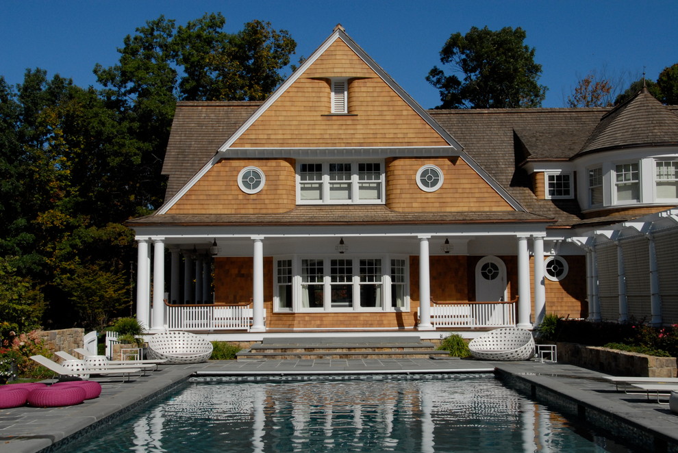 Photo of a traditional exterior in New York with wood siding and a gable roof.