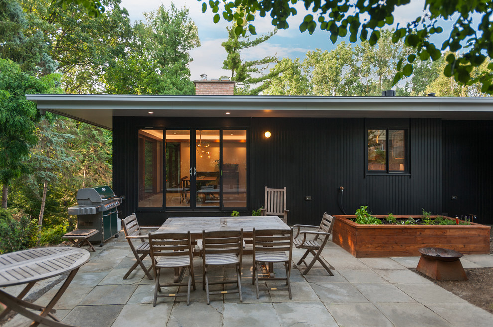 This is an example of a midcentury patio in Detroit.