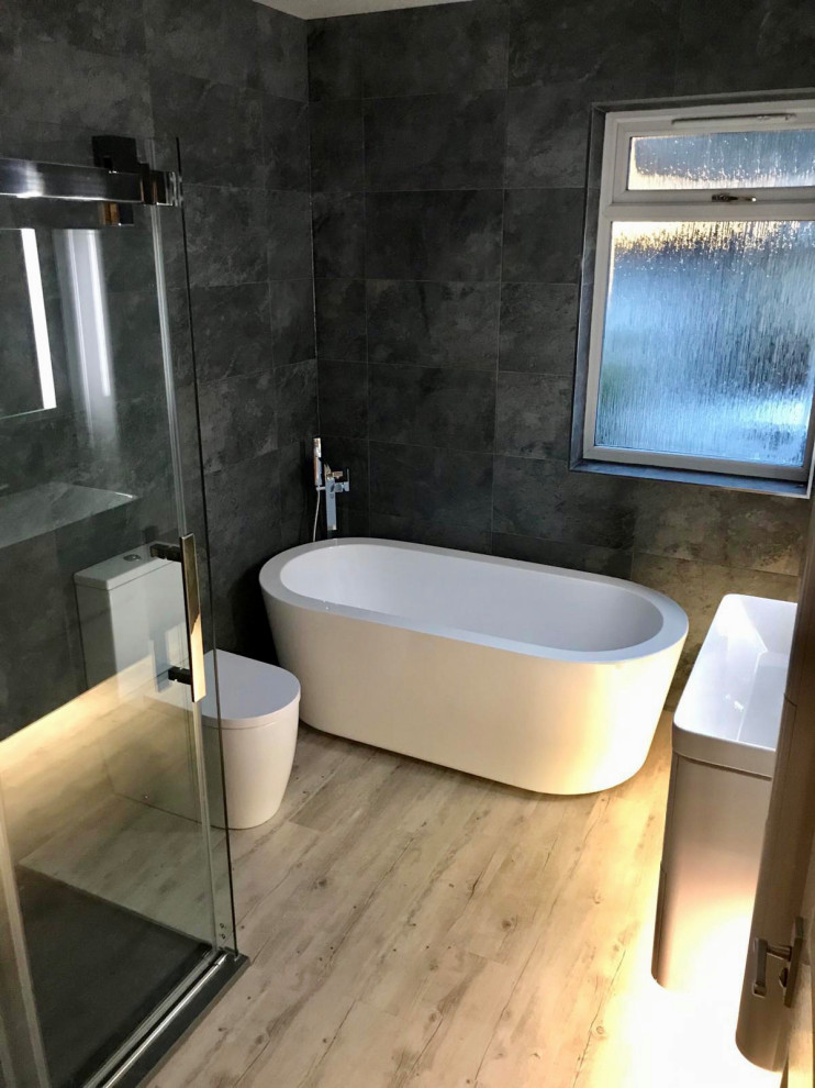 This is an example of a medium sized modern family bathroom in Glasgow with flat-panel cabinets, white cabinets, a freestanding bath, a walk-in shower, a wall mounted toilet, a wall-mounted sink, an open shower, feature lighting, a single sink and a floating vanity unit.
