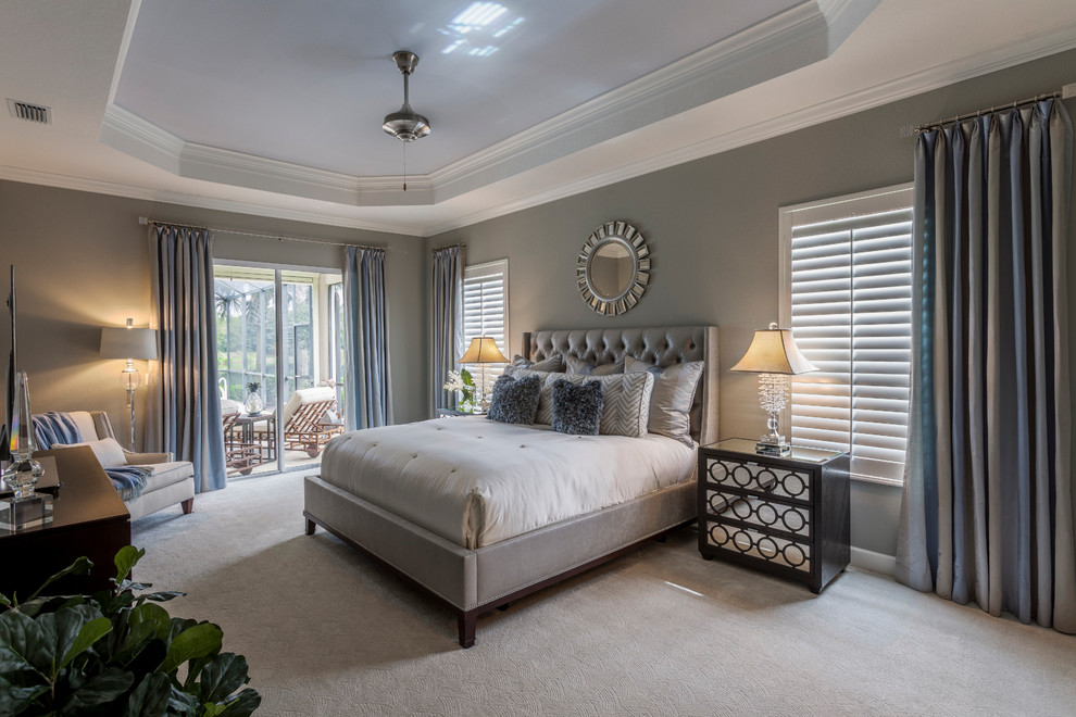 Design ideas for a contemporary bedroom in Tampa with carpet and beige floor.