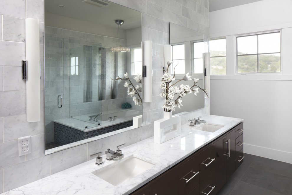 Photo of a contemporary bathroom in Austin with marble benchtops.