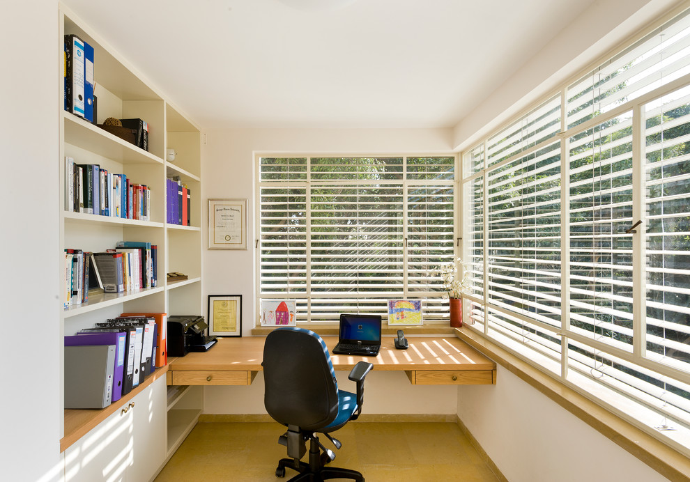 Inspiration for a contemporary home office in Other with a built-in desk and white walls.