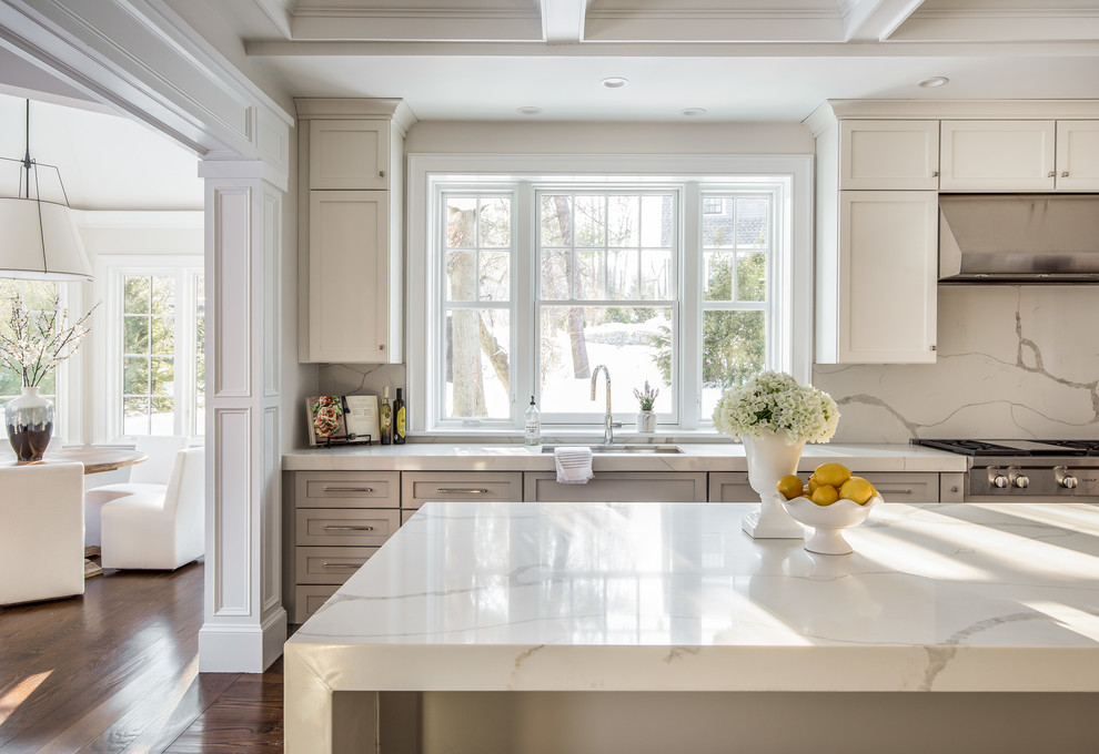 Example of a large transitional galley dark wood floor eat-in kitchen design in Boston with an undermount sink, shaker cabinets, white cabinets, quartz countertops, stone slab backsplash, paneled appliances and an island