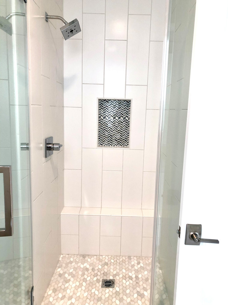Photo of a mid-sized transitional bathroom in Los Angeles with an alcove shower, white tile, mosaic tile, white walls, marble floors, grey floor, a hinged shower door, white benchtops, a shower seat and a single vanity.