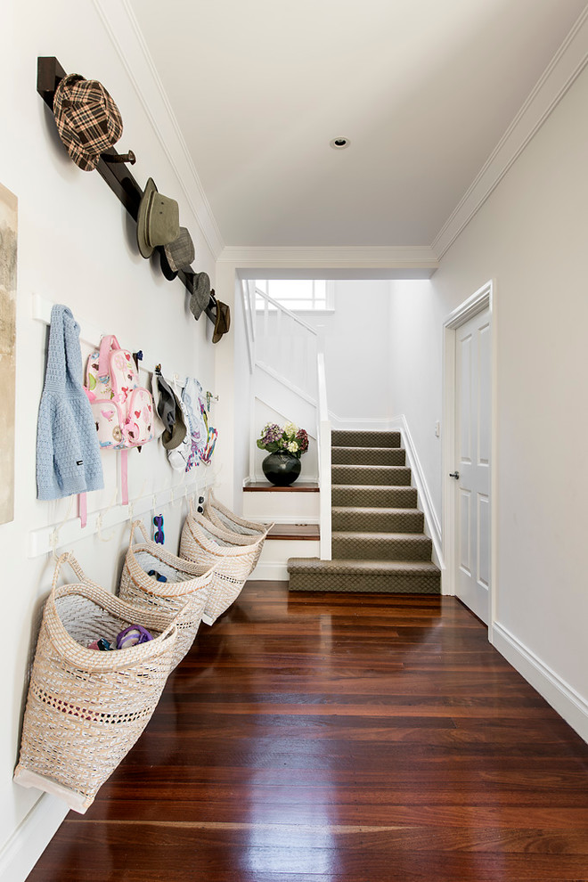 Photo of a mid-sized transitional entryway in Perth with white walls and dark hardwood floors.