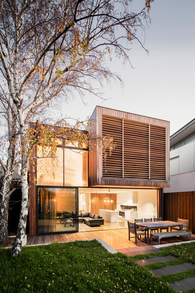 Photo of a mid-sized contemporary two-storey exterior in Melbourne with wood siding and a flat roof.