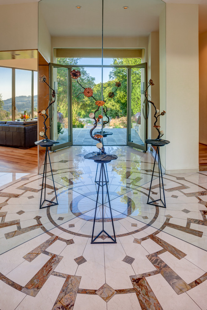 Design ideas for a large contemporary foyer in San Francisco with marble floors, a double front door and a glass front door.