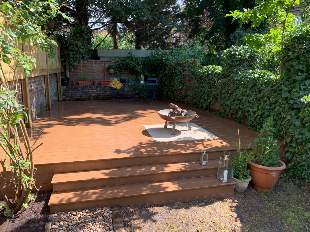 Mid-sized modern backyard partial sun garden in London with decking.