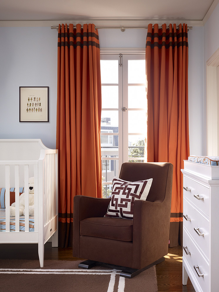 Traditional gender-neutral nursery in San Francisco with blue walls and medium hardwood floors.