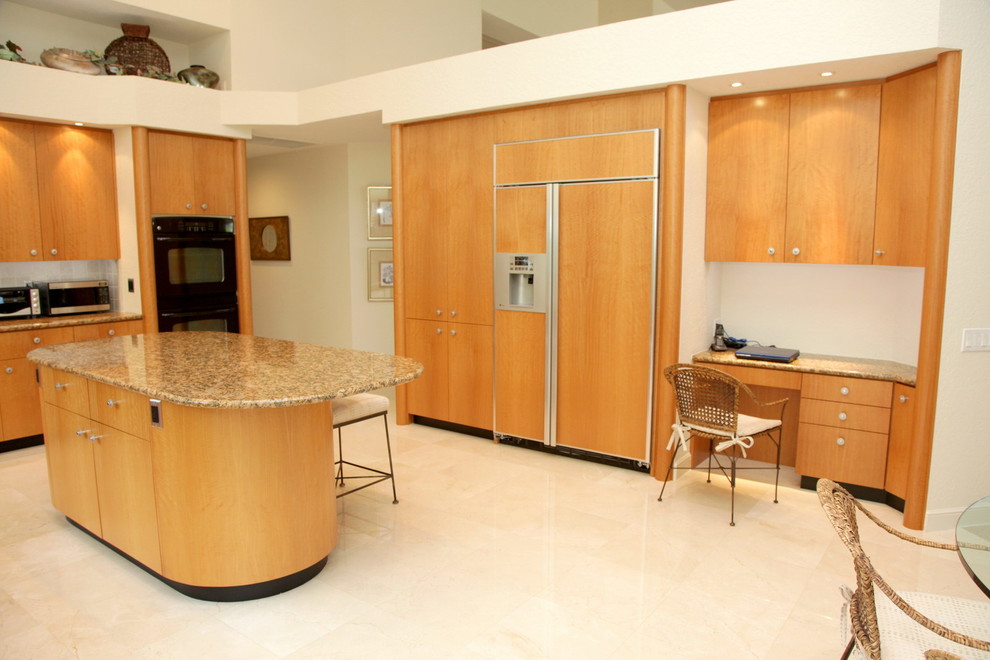 This is an example of a contemporary u-shaped eat-in kitchen in Miami with panelled appliances.