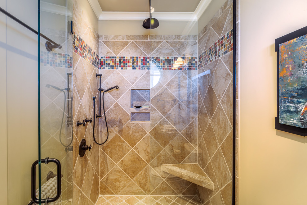 Inspiration for a mid-sized beach style master bathroom in Charleston with a corner shower and beige tile.