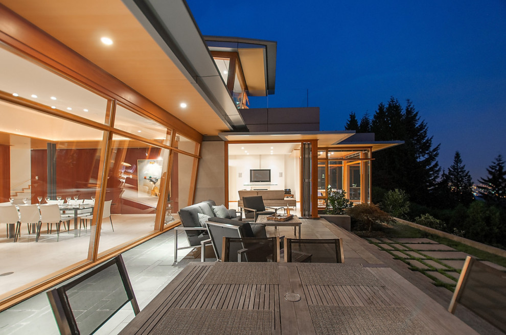 This is an example of a large modern patio in Vancouver.