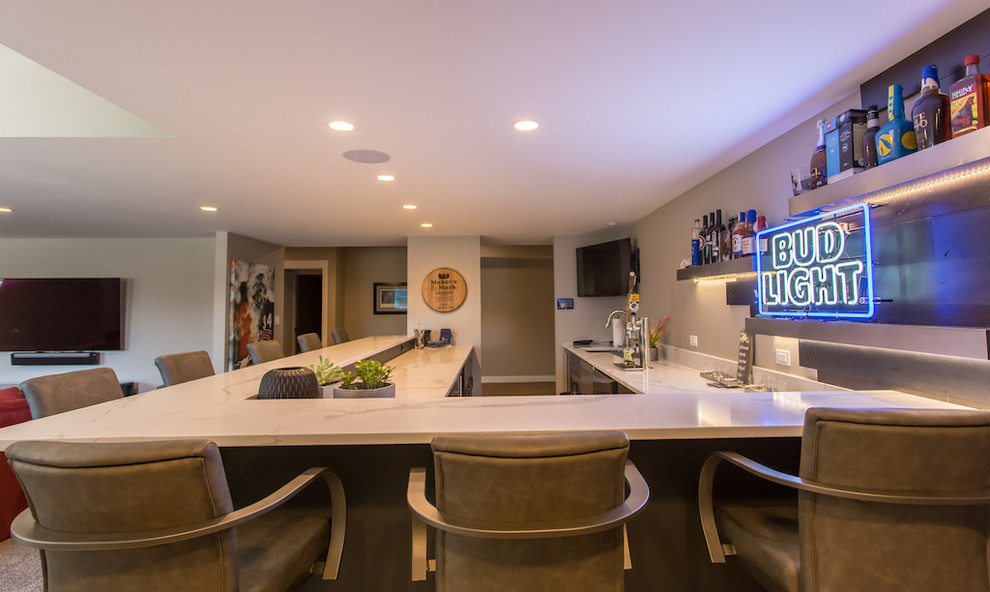 This is an example of a large modern u-shaped wet bar in Chicago with an undermount sink, recessed-panel cabinets, grey cabinets, quartz benchtops, ceramic floors, grey floor and white benchtop.