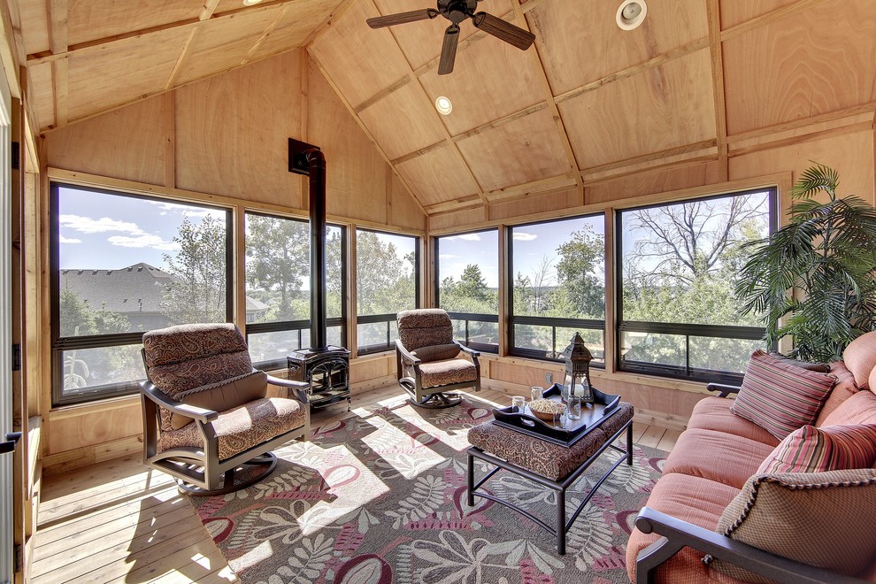 Photo of a traditional sunroom in Minneapolis with medium hardwood floors, no fireplace and a standard ceiling.