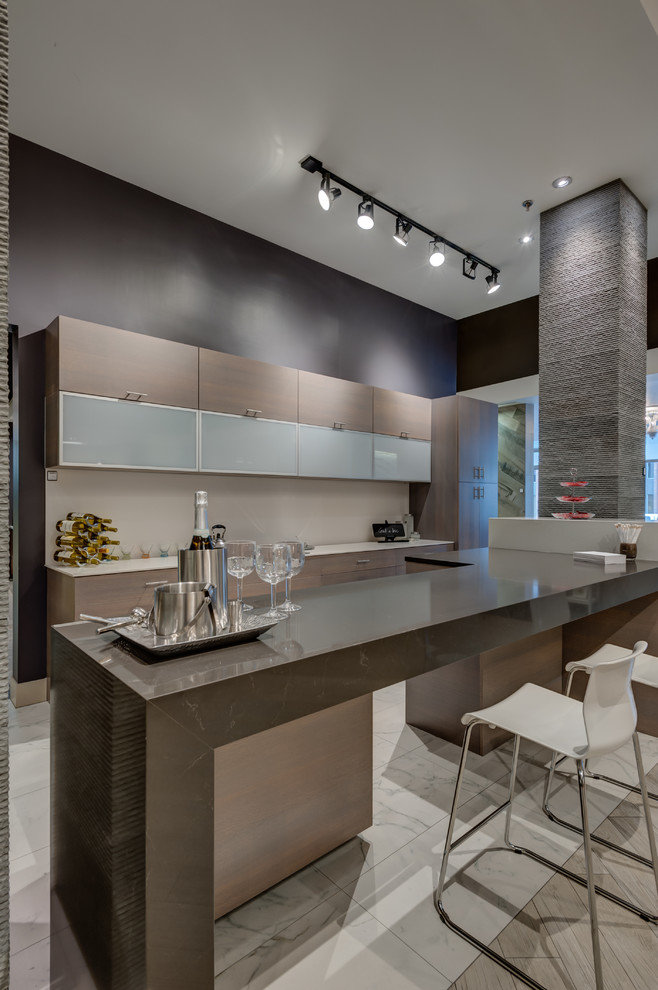 Inspiration for a large modern single-wall seated home bar in Seattle with quartz benchtops, flat-panel cabinets, beige cabinets, marble floors and grey floor.