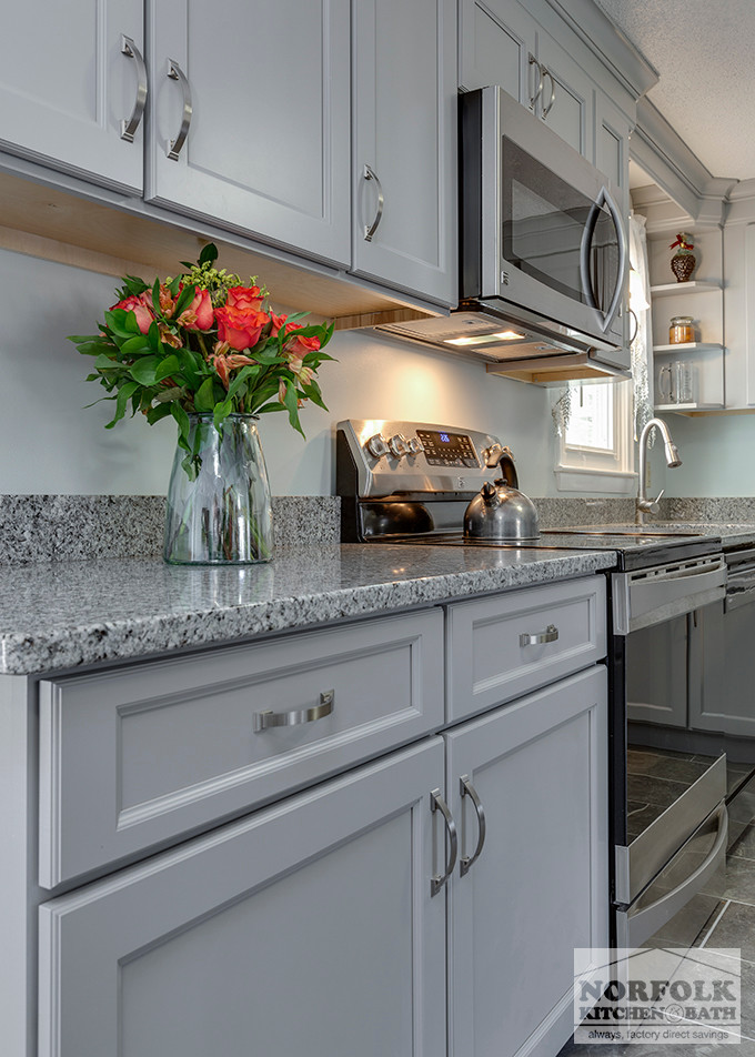Example of a mid-sized transitional u-shaped home design design in Boston with an undermount sink, shaker cabinets, gray cabinets, granite countertops, stainless steel appliances and no island
