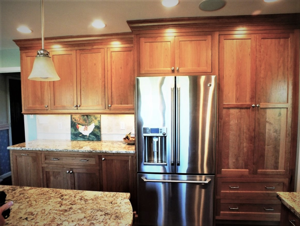 Kitchen - large transitional u-shaped cork floor kitchen idea with beaded inset cabinets, medium tone wood cabinets, granite countertops, blue backsplash, stone tile backsplash, stainless steel appliances and an island