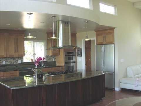 This is an example of a mid-sized modern u-shaped kitchen in Orange County with an undermount sink, shaker cabinets, medium wood cabinets, multi-coloured splashback, stainless steel appliances, medium hardwood floors, with island, mosaic tile splashback, brown floor, green benchtop and coffered.