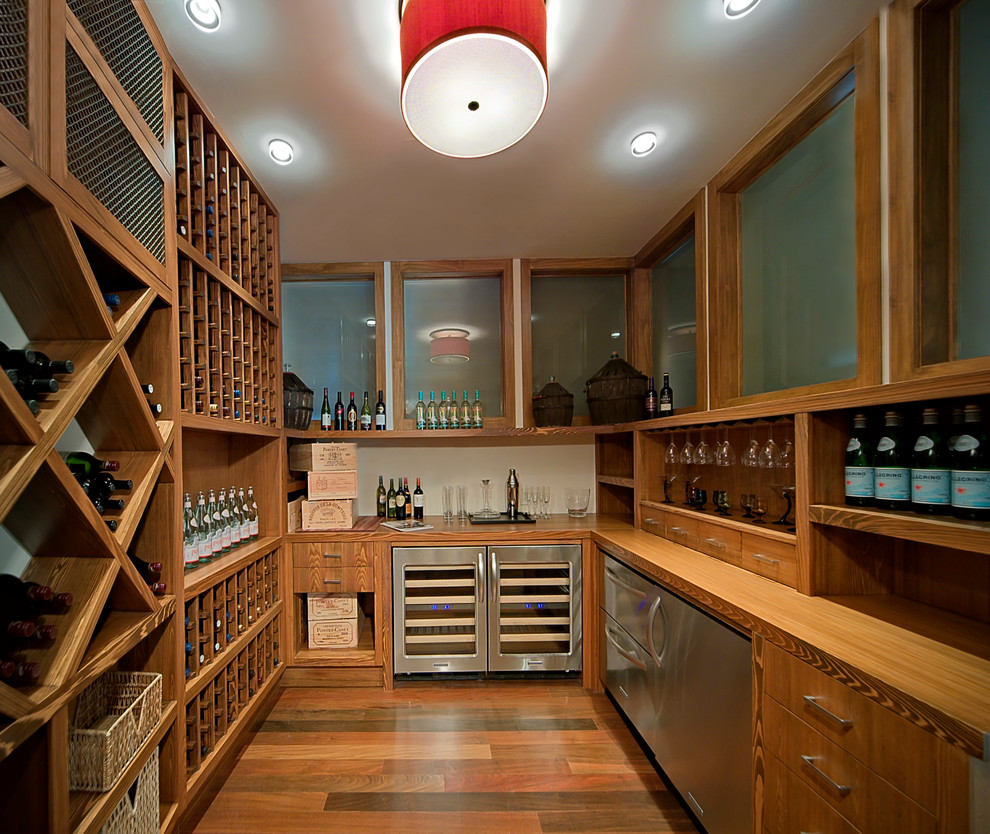This is an example of a large contemporary wine cellar in Orlando with medium hardwood floors, storage racks and brown floor.