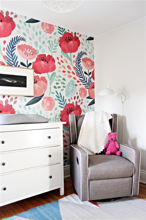 Design ideas for a mid-sized modern nursery for girls in Toronto with grey walls and light hardwood floors.