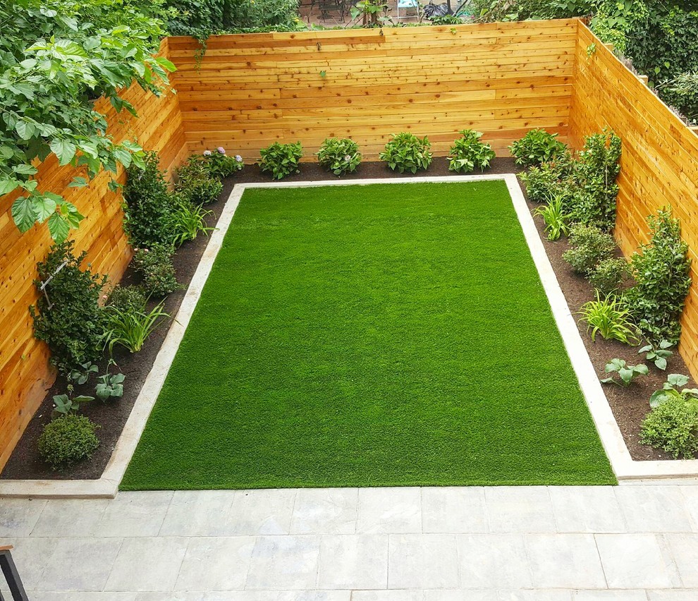 Mid-sized modern backyard full sun garden in New York with concrete pavers.