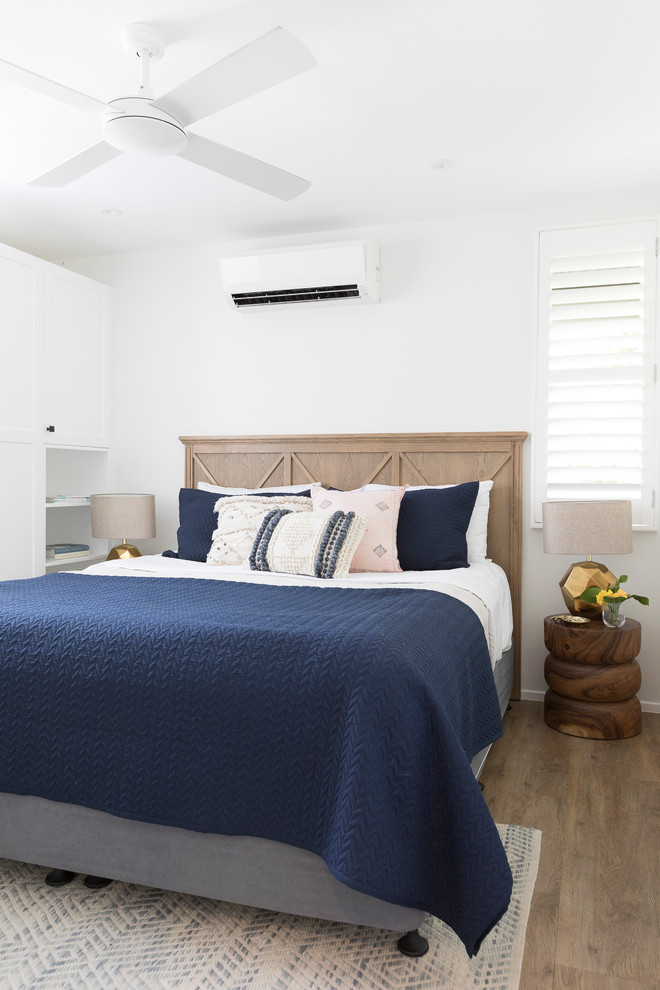 Photo of a contemporary bedroom in Brisbane with white walls and light hardwood floors.