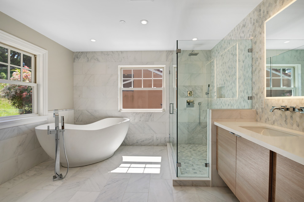 Country master bathroom in San Francisco with flat-panel cabinets, medium wood cabinets, a freestanding tub, a corner shower, gray tile, white tile, marble, beige walls, marble floors, an undermount sink, grey floor, a hinged shower door and beige benchtops.