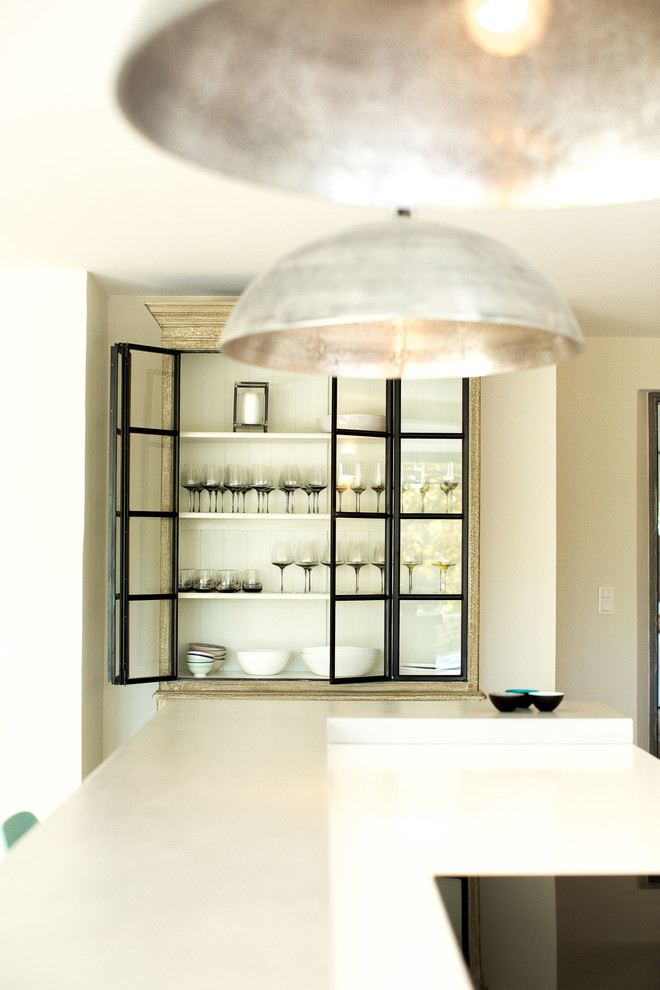 This is an example of a large contemporary single-wall separate kitchen in London with with island.