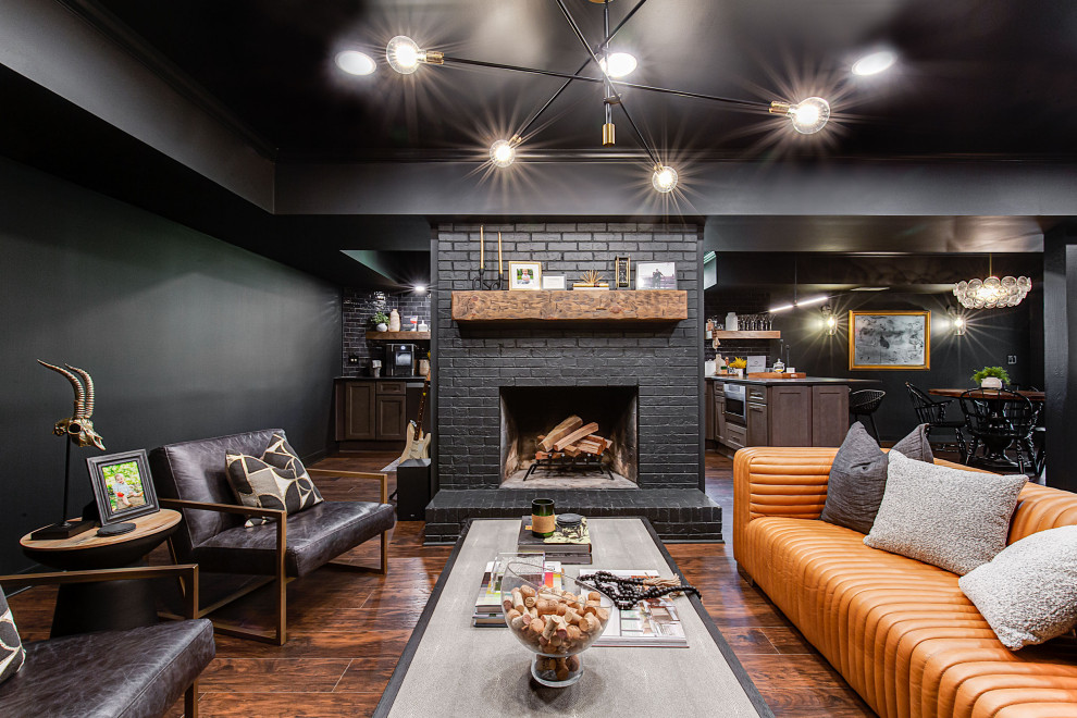 Inspiration for a large contemporary walk-out vinyl floor, brown floor and shiplap wall basement remodel in Atlanta with a bar, black walls, a standard fireplace and a brick fireplace