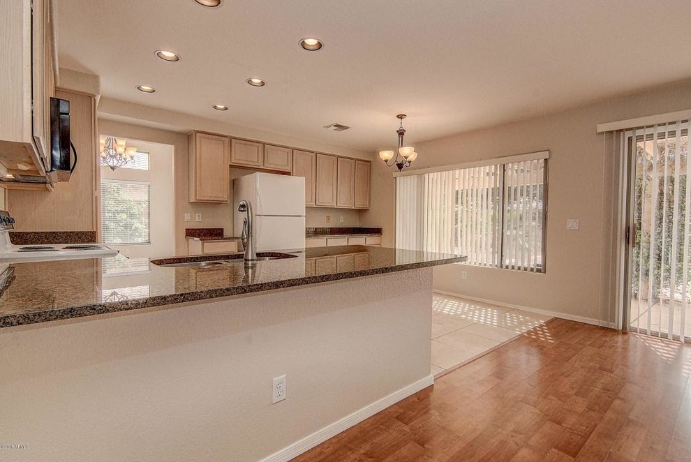 Large transitional u-shaped ceramic tile and beige floor open concept kitchen photo in Phoenix with a double-bowl sink, recessed-panel cabinets, light wood cabinets, granite countertops, beige backsplash, white appliances and a peninsula