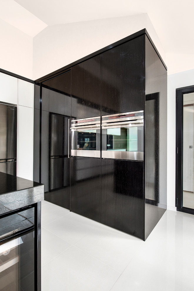 Design ideas for a large contemporary l-shaped eat-in kitchen in Sydney with a double-bowl sink, flat-panel cabinets, dark wood cabinets, black splashback, glass sheet splashback, stainless steel appliances, porcelain floors, with island and stainless steel benchtops.