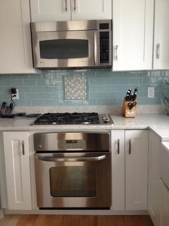 Example of a transitional u-shaped vinyl floor eat-in kitchen design in Boston with recessed-panel cabinets, white cabinets, granite countertops, blue backsplash, mosaic tile backsplash, stainless steel appliances and no island