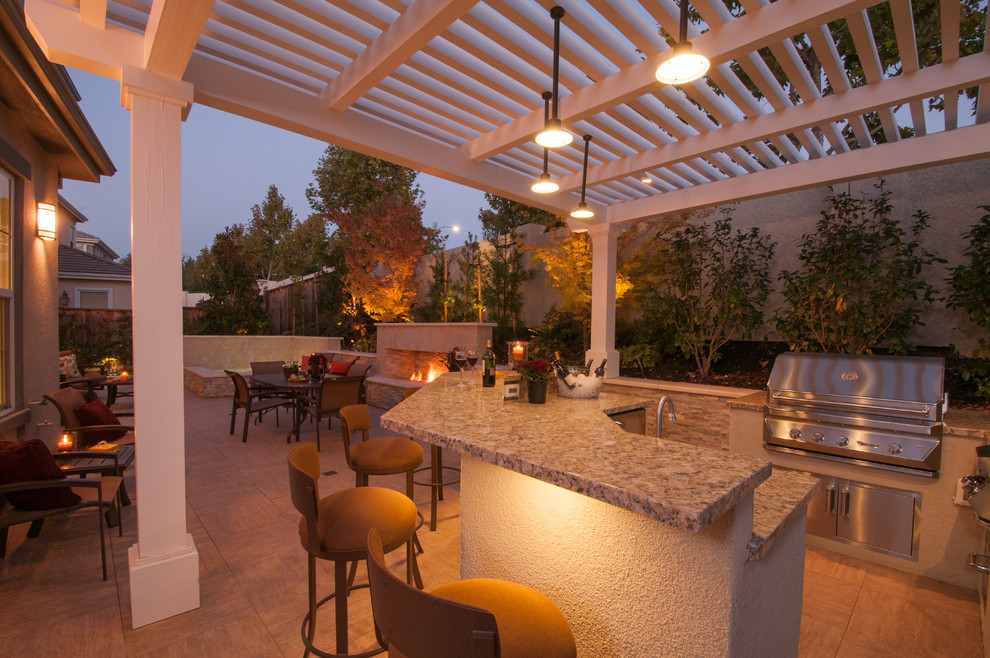 Inspiration for a large contemporary backyard patio in San Francisco with an outdoor kitchen, tile and a pergola.