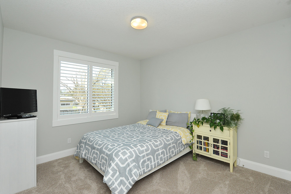 Inspiration for a mid-sized modern guest bedroom in Calgary with grey walls, carpet, no fireplace and beige floor.
