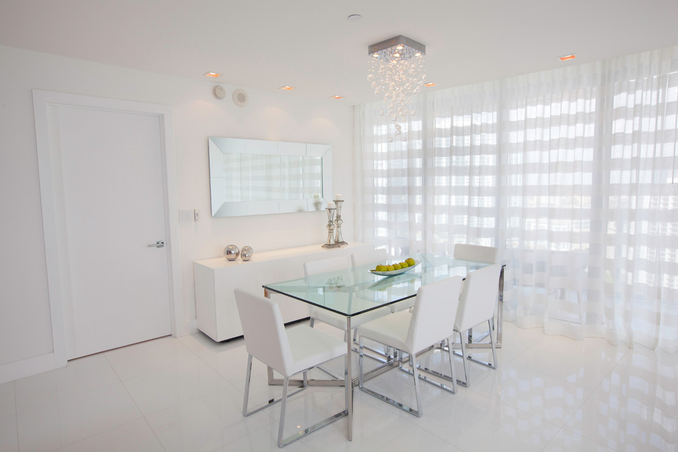This is an example of a mid-sized contemporary open plan dining in Miami with white walls, no fireplace and white floor.