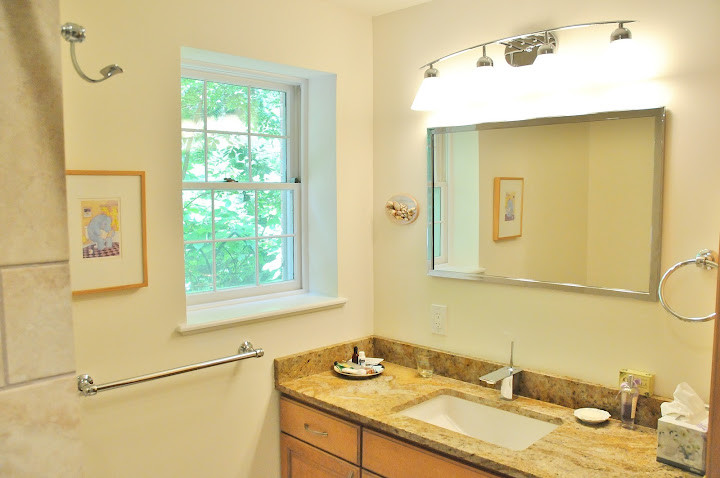 This is an example of a mid-sized traditional bathroom in Baltimore with raised-panel cabinets, light wood cabinets, beige tile, ceramic tile, beige walls, travertine floors, an undermount sink, granite benchtops and with a sauna.