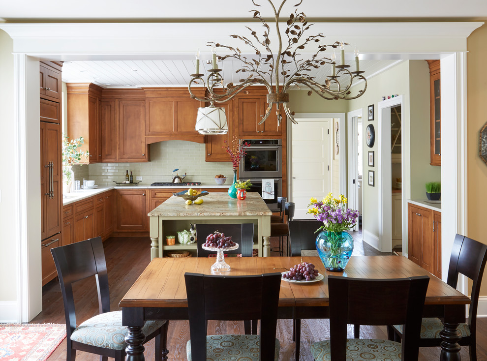 Inspiration for a mid-sized rustic u-shaped dark wood floor eat-in kitchen remodel with a double-bowl sink, raised-panel cabinets, light wood cabinets, marble countertops, white backsplash, mosaic tile backsplash, stainless steel appliances and an island