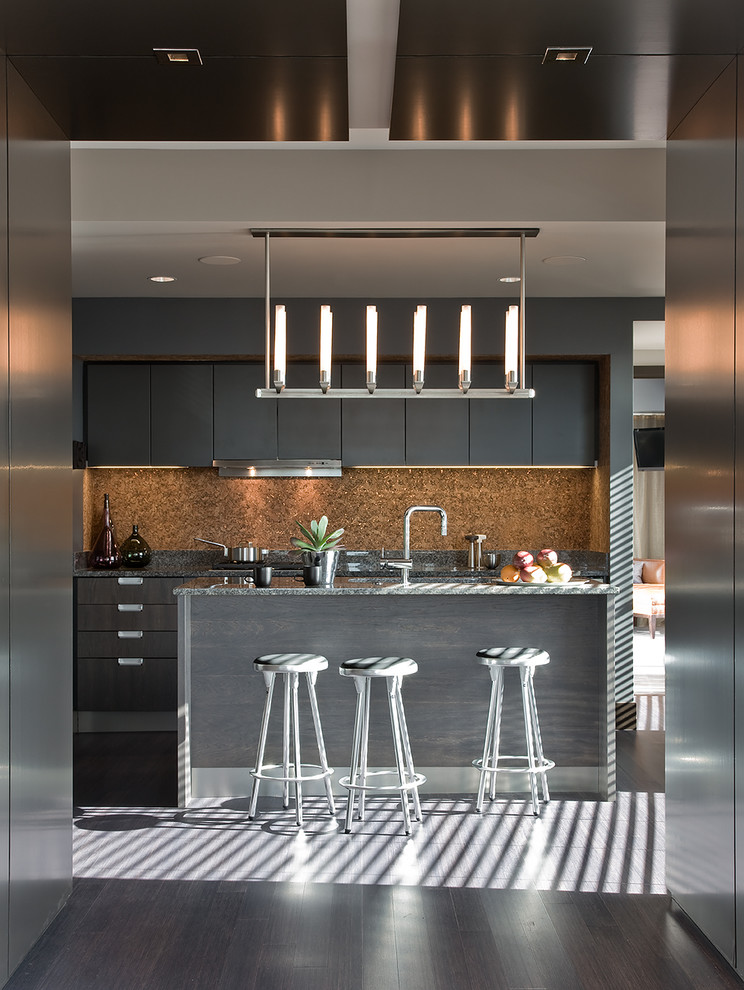 Photo of a mid-sized contemporary single-wall eat-in kitchen in Boston with grey cabinets, an undermount sink, flat-panel cabinets, granite benchtops, brown splashback, stainless steel appliances, dark hardwood floors and with island.