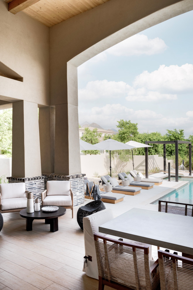 Hot tub - large transitional backyard stone and custom-shaped infinity hot tub idea in Phoenix