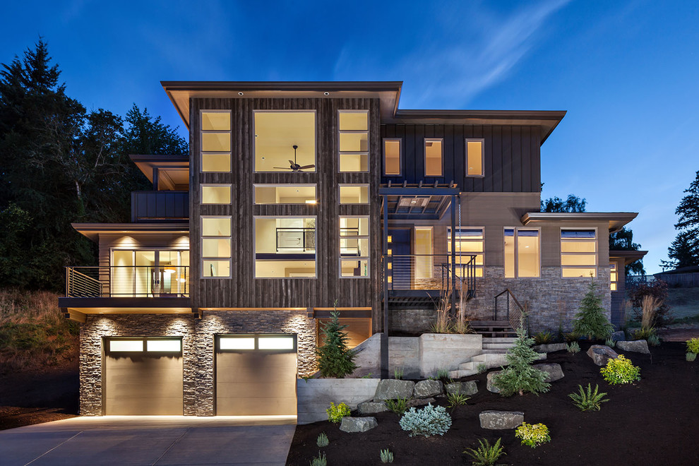 Design ideas for a large contemporary three-storey beige exterior in Portland with wood siding and a hip roof.