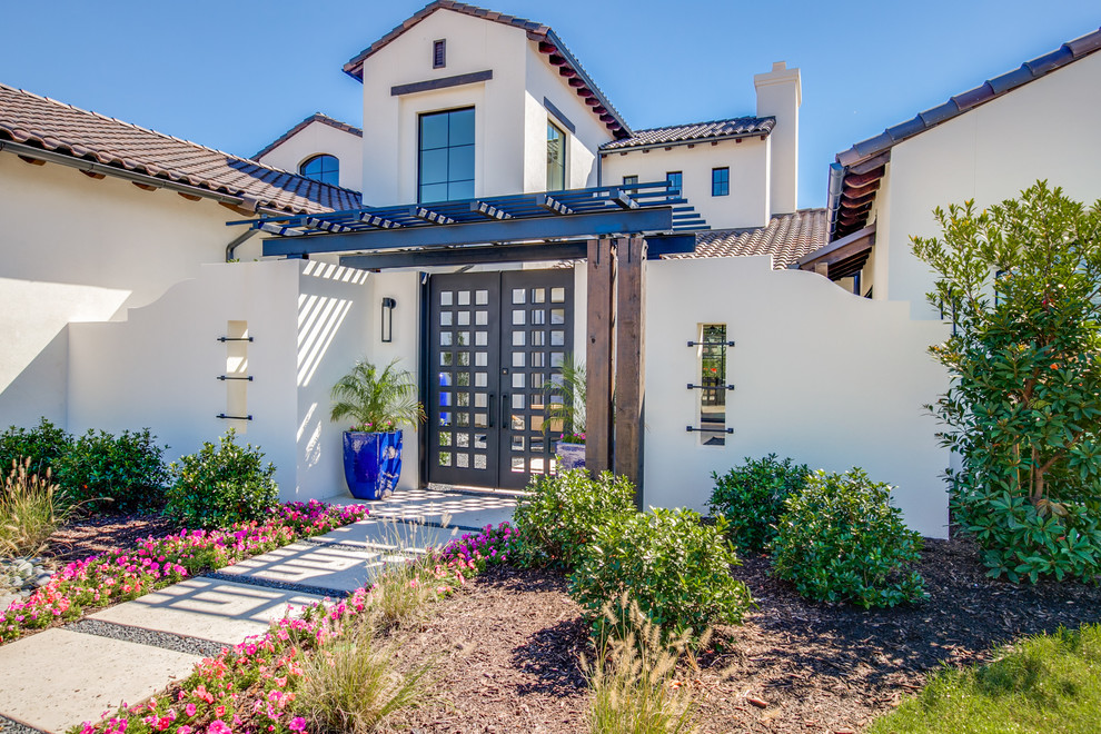 Photo of a large mediterranean two-storey stucco white house exterior in Dallas.