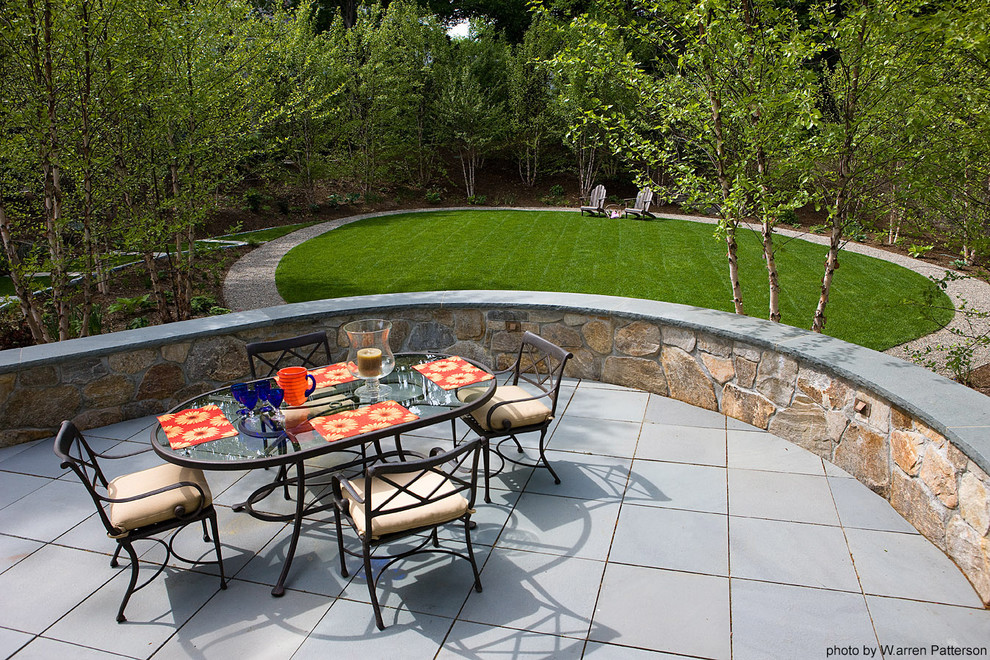 Photo of a large traditional courtyard patio in Boston with natural stone pavers and no cover.