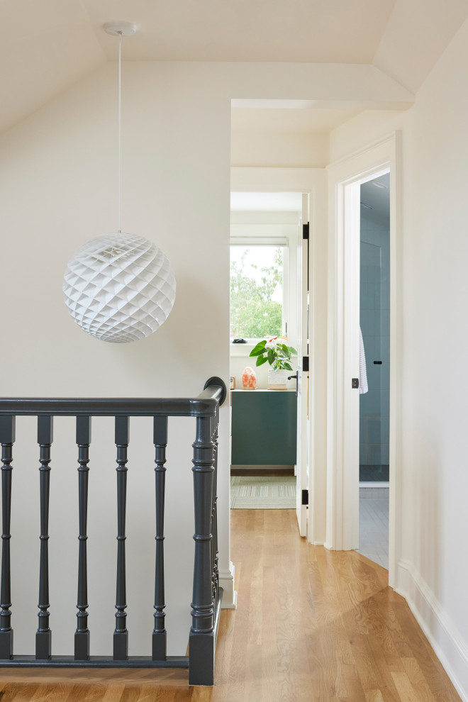 Example of a mid-sized ornate light wood floor hallway design in Seattle with white walls