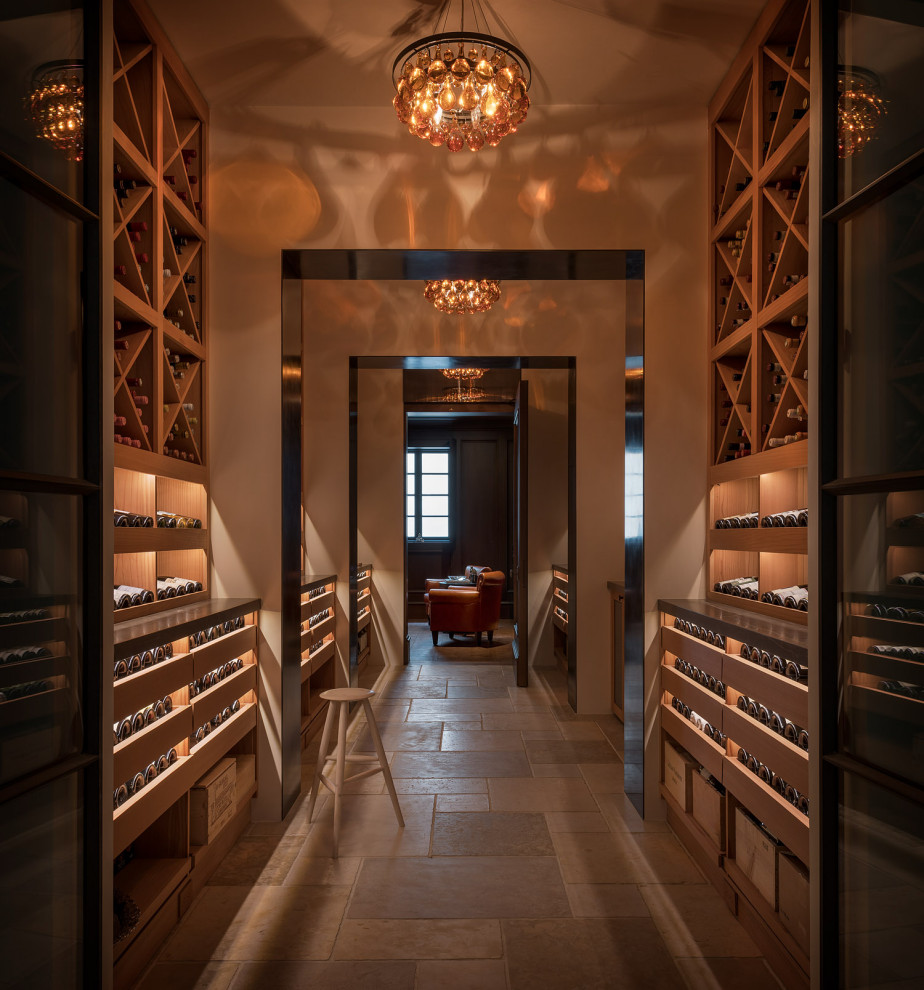 Inspiration for a wine cellar in San Francisco with limestone floors and display racks.