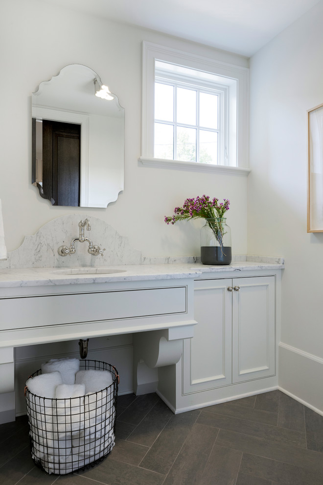 This is an example of a large traditional kids bathroom in Minneapolis with beaded inset cabinets, white cabinets, a claw-foot tub, a curbless shower, a two-piece toilet, white tile, marble, white walls, mosaic tile floors, a drop-in sink, marble benchtops, grey floor, a hinged shower door and white benchtops.