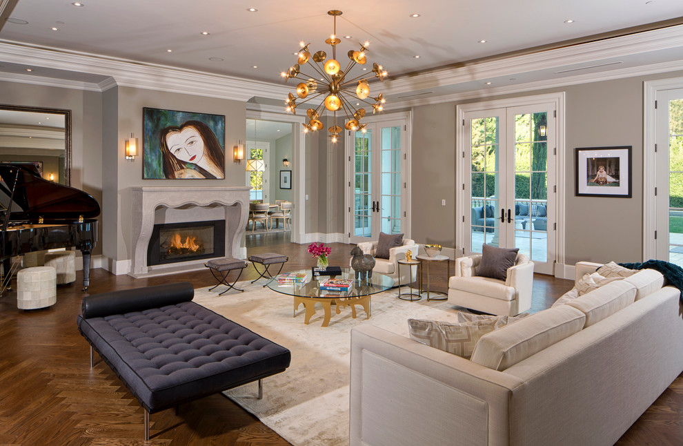 Example of a transitional dark wood floor living room design in Los Angeles with gray walls and a standard fireplace
