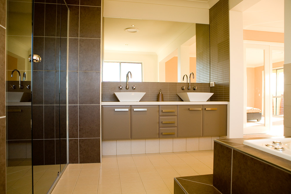 Inspiration for a mid-sized contemporary bathroom in Brisbane with a vessel sink, flat-panel cabinets, brown cabinets, laminate benchtops, a drop-in tub, a curbless shower, a one-piece toilet, brown tile, ceramic tile, beige walls and ceramic floors.