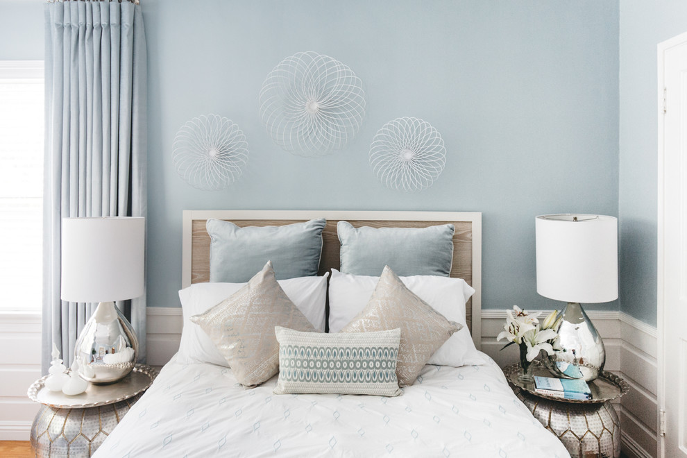 Inspiration for a small modern guest bedroom in Los Angeles with blue walls and medium hardwood floors.