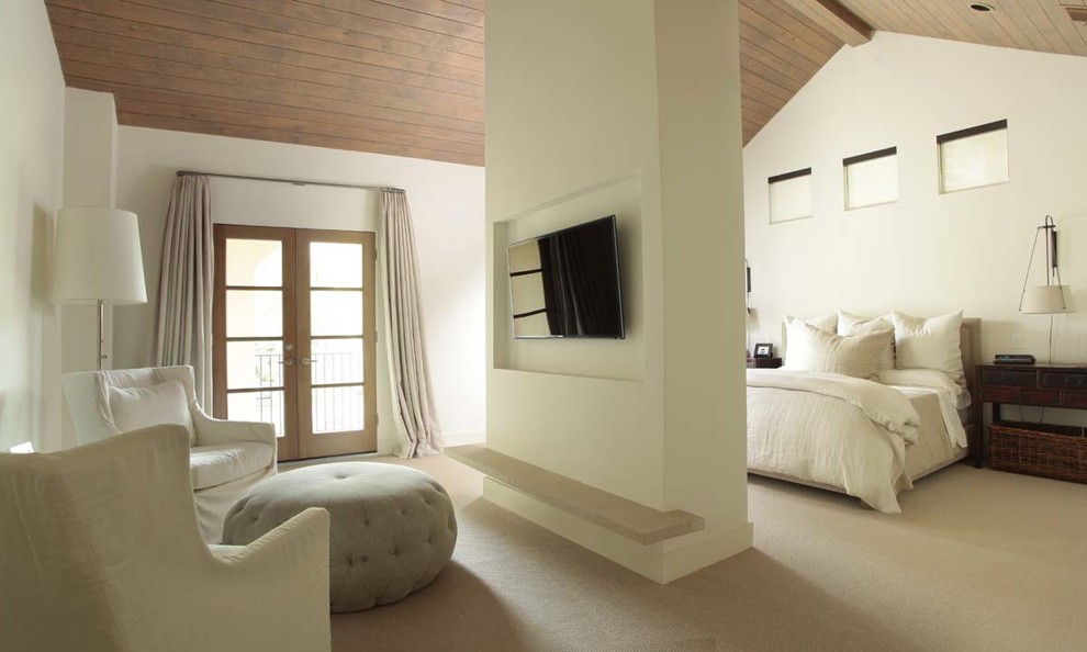 Design ideas for a large transitional master bedroom in Houston with beige walls and carpet.